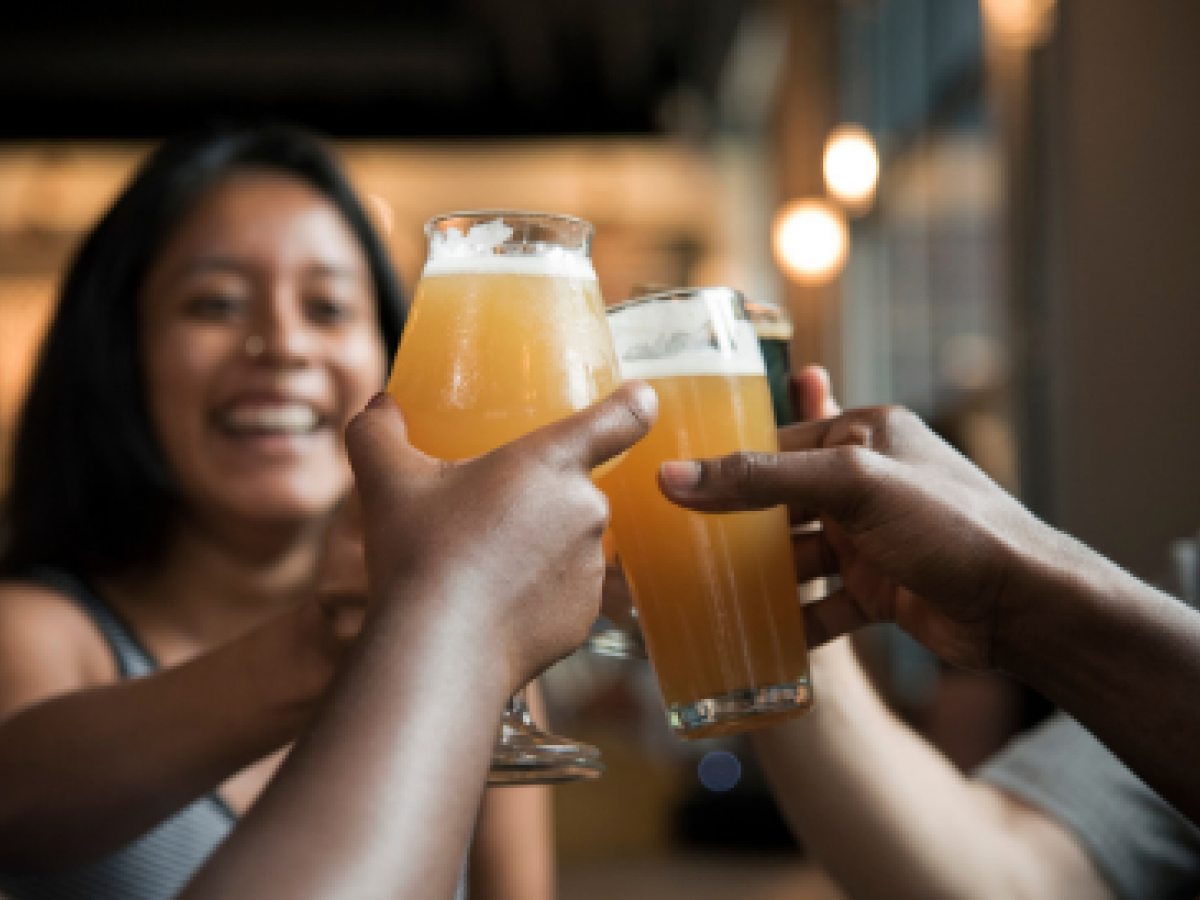 people raising a toast with beer