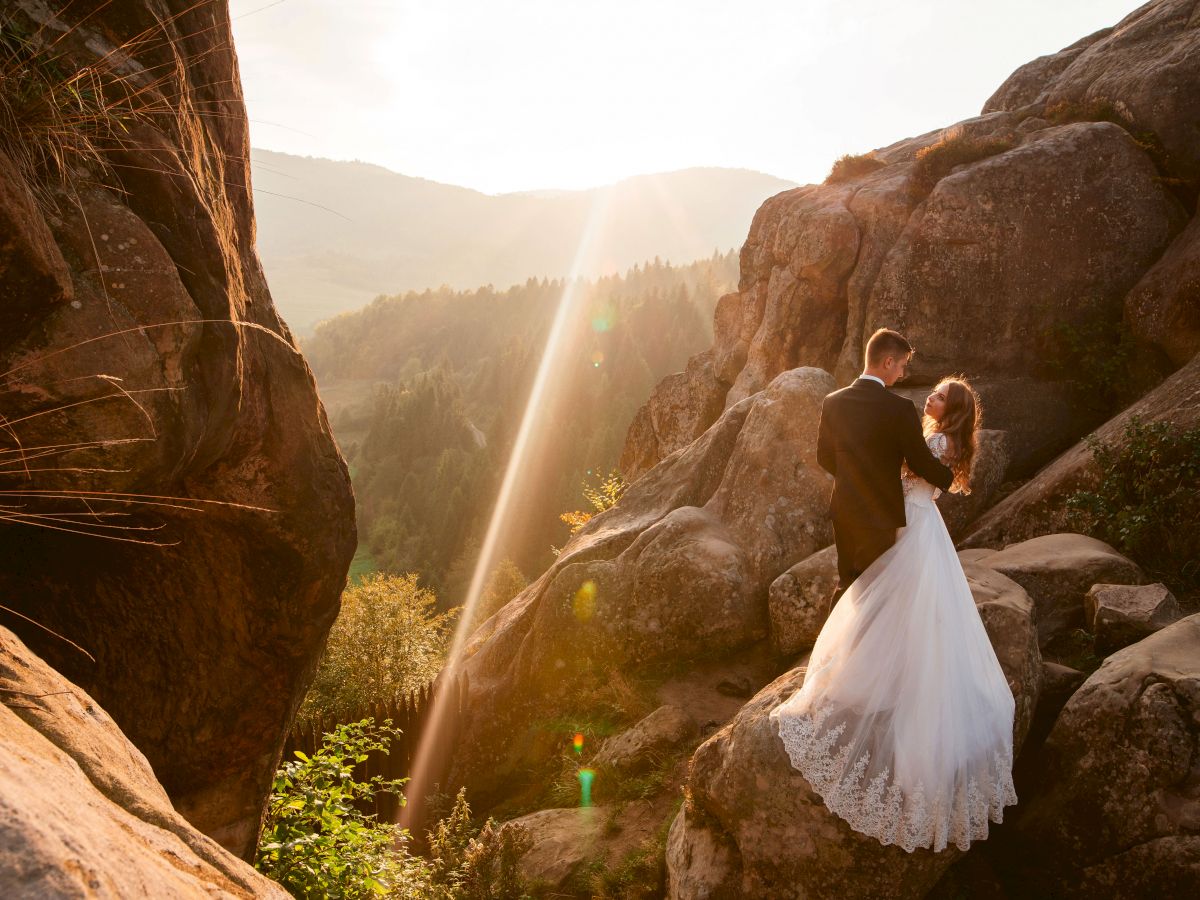 wedding couple standing at mountain view