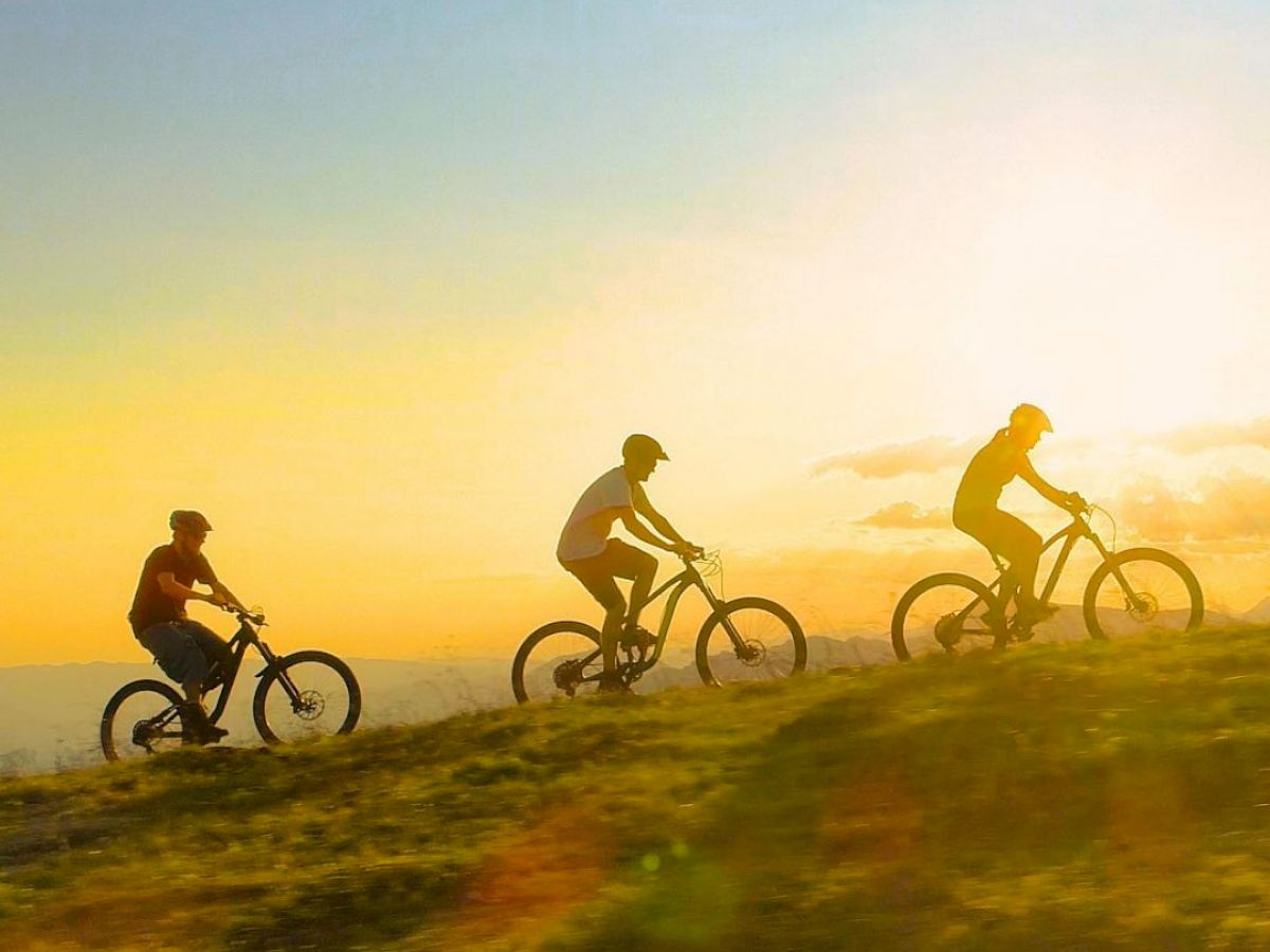 3 people mountain biking
