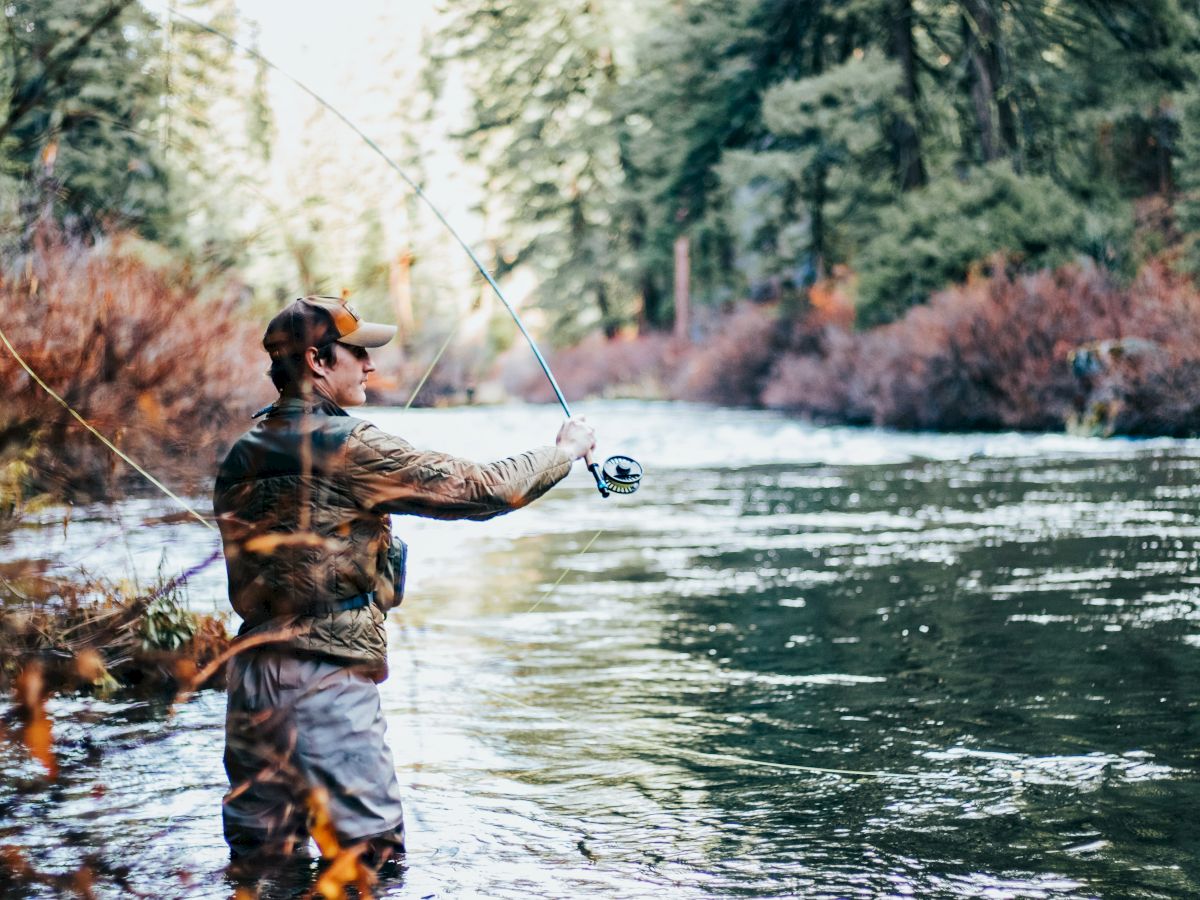 person fly fishing in river