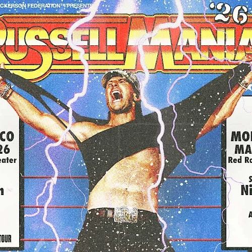 A wrestling concert flyer for Russellmania, featuring a muscular performer on stage with arms raised, lightning effects, and event details in Morrison, CO. The design is bold with red-yellow text and starry blue background, labeled &ldquo;RUSSELLMANIA.&rdquo;