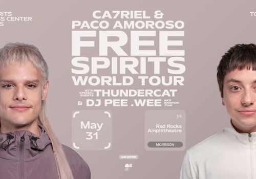 Two men face the camera in a promotional poster for the Free Spirits World Tour, with bold white text and tour details in the center.