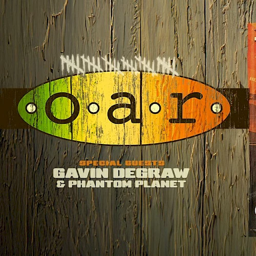 G.n. gear poster and a road trip flyer, featuring the word &ldquo;gear,&rdquo; a vintage car, and &ldquo;Three Decades Tour&rdquo; concert ad, on a wooden background.